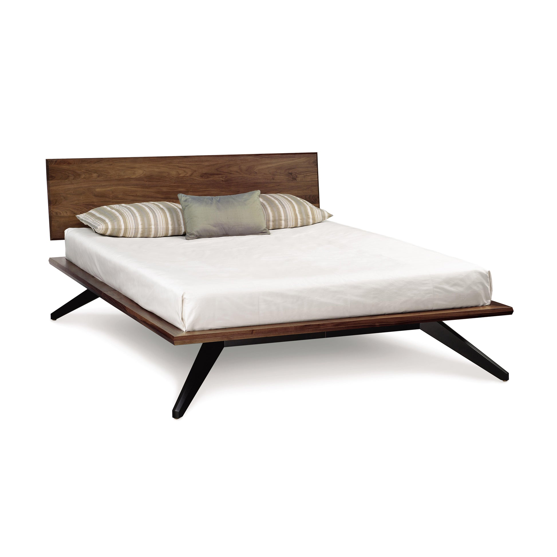 Astrid Walnut Platform Bed by Copeland Furniture with a mid-century modern design, featuring a wooden headboard and distinctive black angled legs.