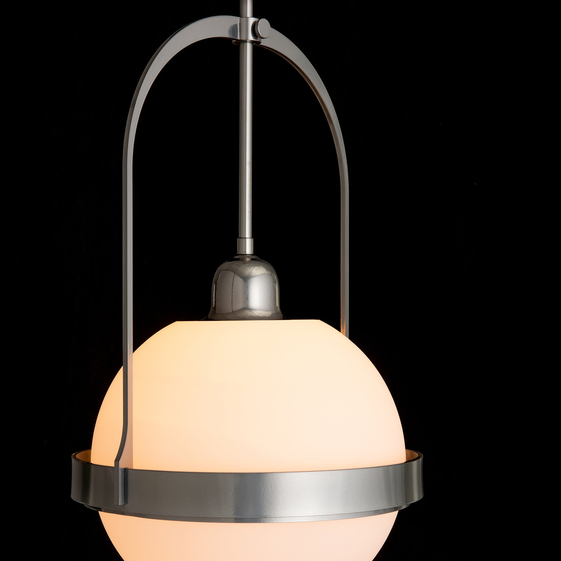 The Hubbardton Forge Atlas Mini Pendant is a Hubbardton Forge lighting fixture, handcrafted in Vermont, with a stunning glass globe hanging from it.