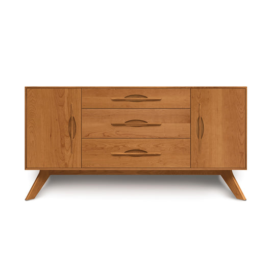 A wooden mid-century modern style Copeland Furniture Audrey 2-Door 3-Drawer Buffet with tapered legs and four drawers with carved handles, isolated on a white background.