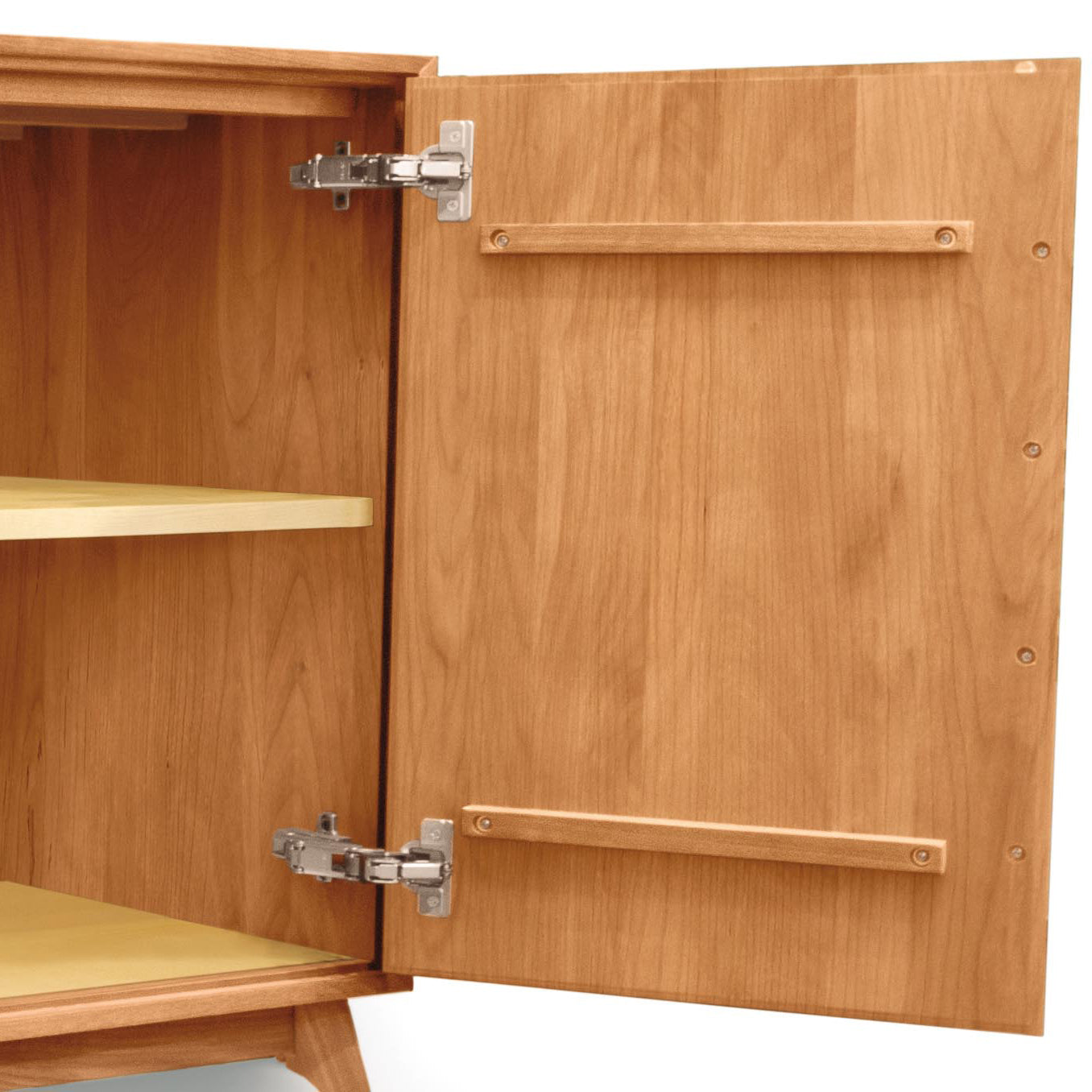 A Audrey 2-Door 3-Drawer Buffet with an open door revealing internal shelves, featuring metal hinges and a metal handle on the door, crafted by Copeland Furniture.