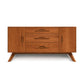 A mid-century modern wood Audrey 2-Door 3-Drawer Buffet with tapered legs and four drawers with horizontal cut-out handles against a white background. (Copeland Furniture)