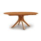 A Audrey Round Extension Dining Table with a wooden base made from solid wood by Copeland Furniture.