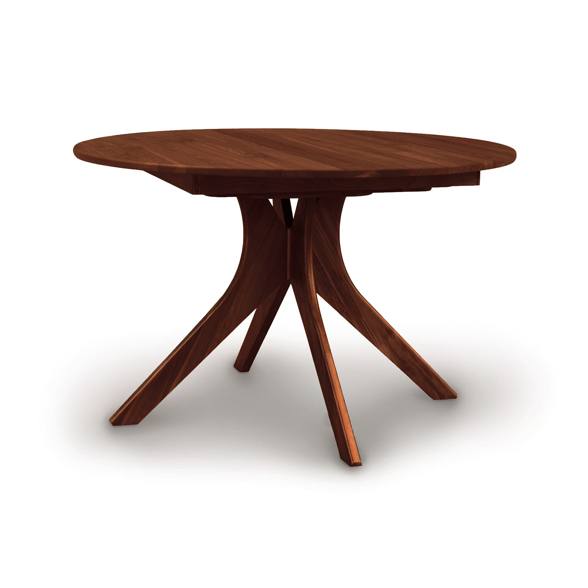 A Copeland Furniture Audrey Round Extension Dining Table with a radial base design and a butterfly leaf mechanism, isolated on a white background.