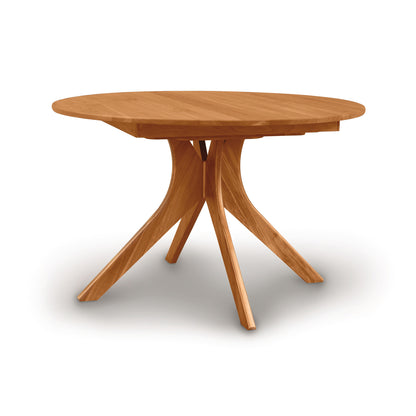 A Audrey Round Extension Dining Table by Copeland Furniture with a cross-leg design on a white background.