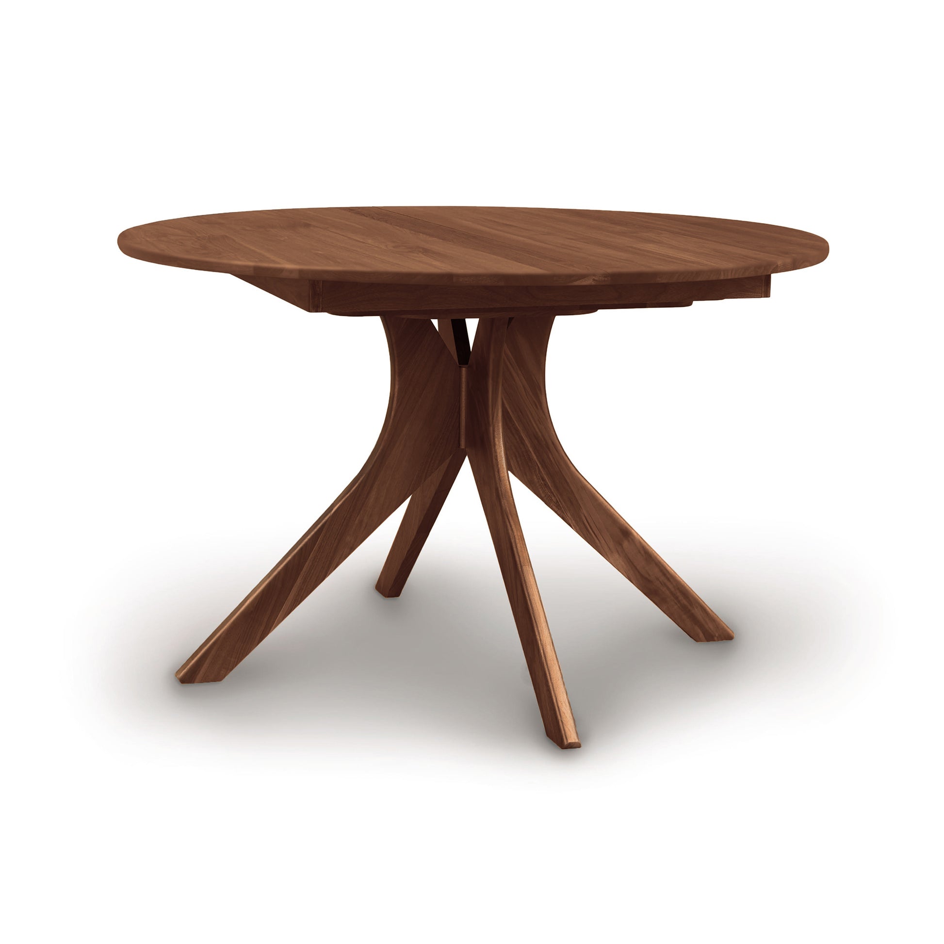 An Audrey Round Extension Dining Table, made of walnut, with three legs on a white background.