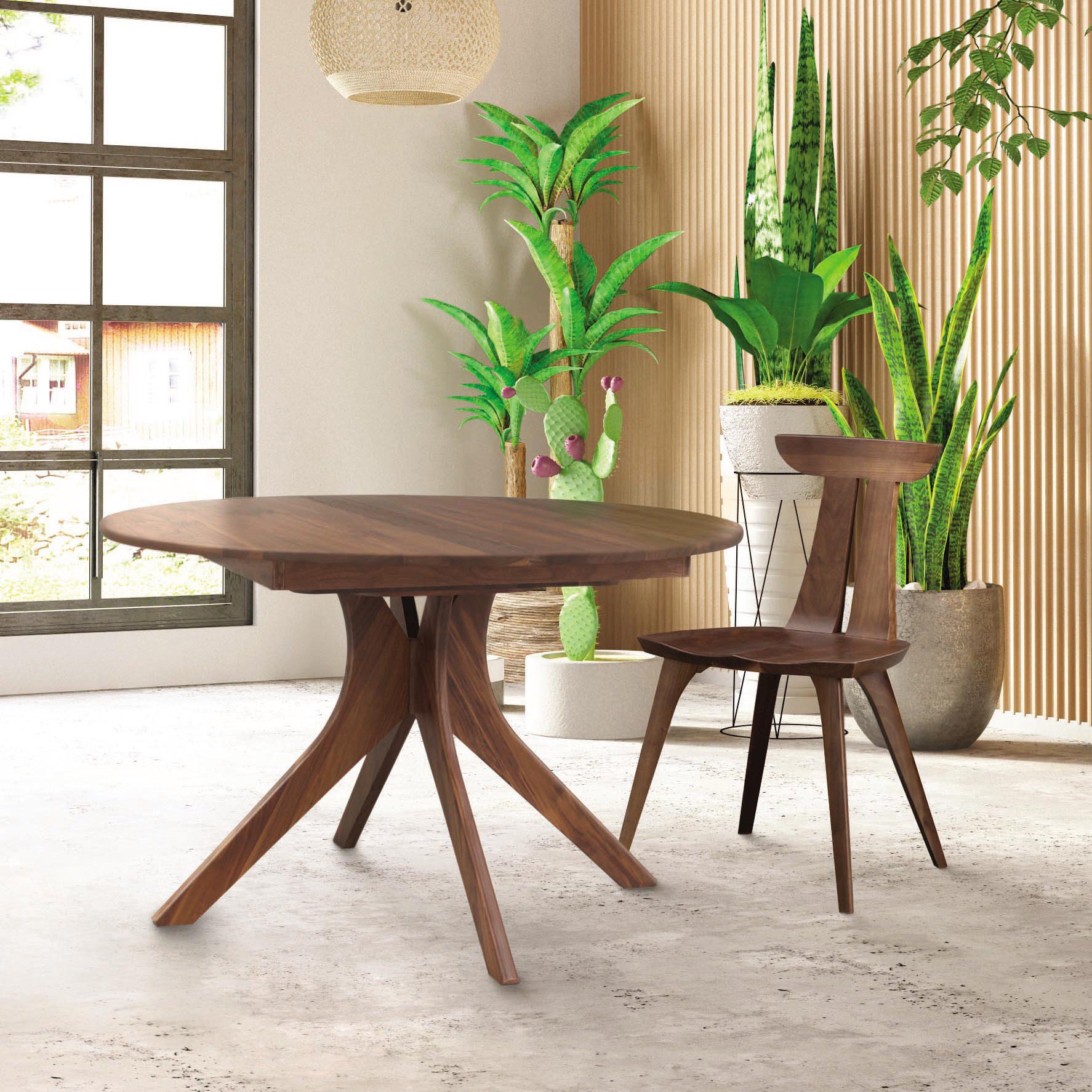 A modern dining room features the Audrey Round Extension Dining Table by Copeland Furniture with a tripod base, paired with matching wooden chairs. The space is adorned with potted plants, including a cactus, and is illuminated by ample natural light from a large window. The wall behind the table showcases vertical wood paneling, also from Copeland Furniture.