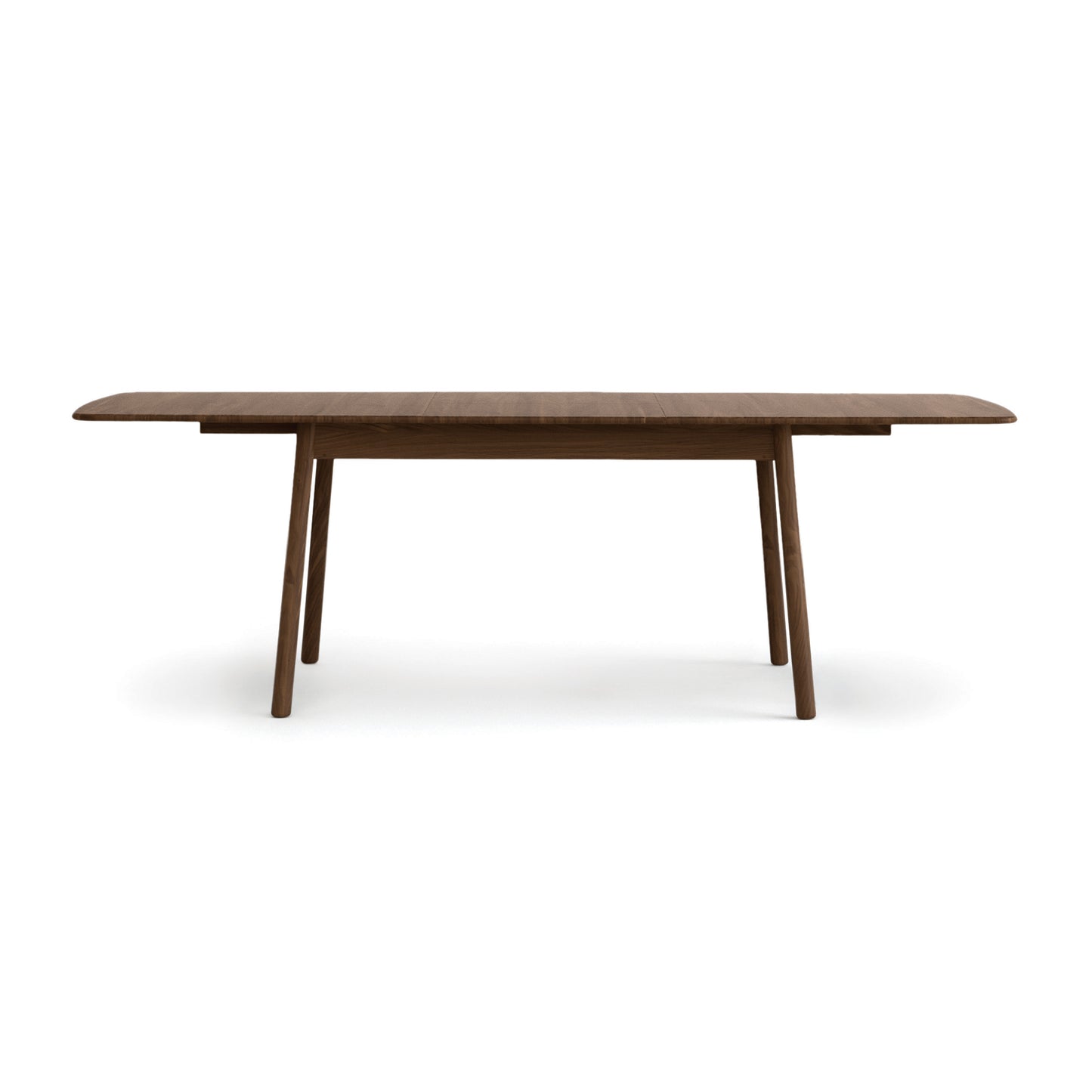 Baton Extension Dining Table by Copeland Furniture with rounded corners and angled legs, crafted in American-made hardwood, focus on table.