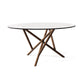 Baton Round Glass Top Table by Copeland Furniture with elegant intersecting wooden legs, highlighting American craftsmanship.