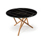 Baton Round Sintered Stone Top Table by Copeland Furniture with black marble surface, gold veining, and intersecting solid wood legs. American made.