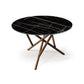 Baton Round Table by Copeland Furniture features a modern sintered stone top and intersecting wooden legs, handcrafted in America for lasting quality.