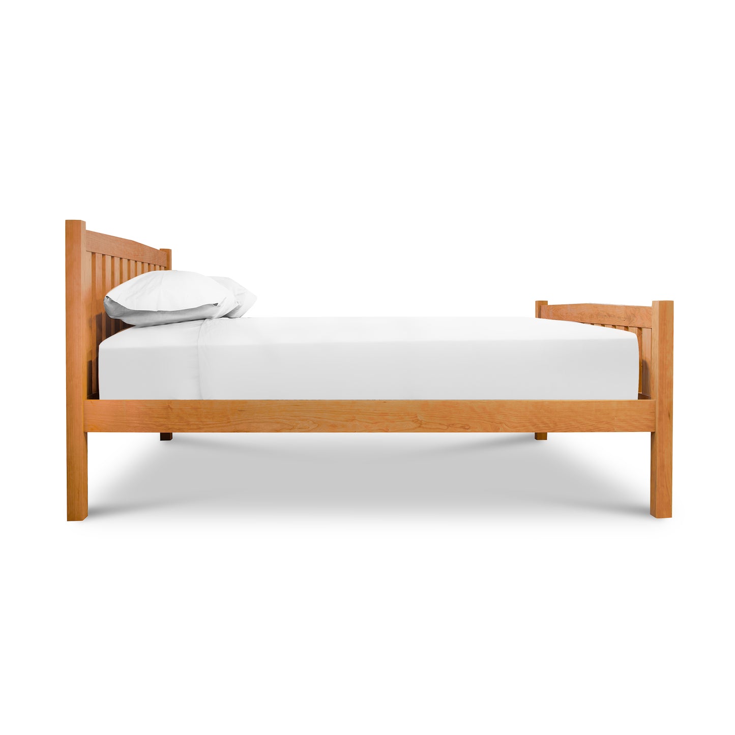 A solid cherry wood Vermont Furniture Designs Bennington Bed with High Footboard - Queen - Floor Model with white sheets on it.