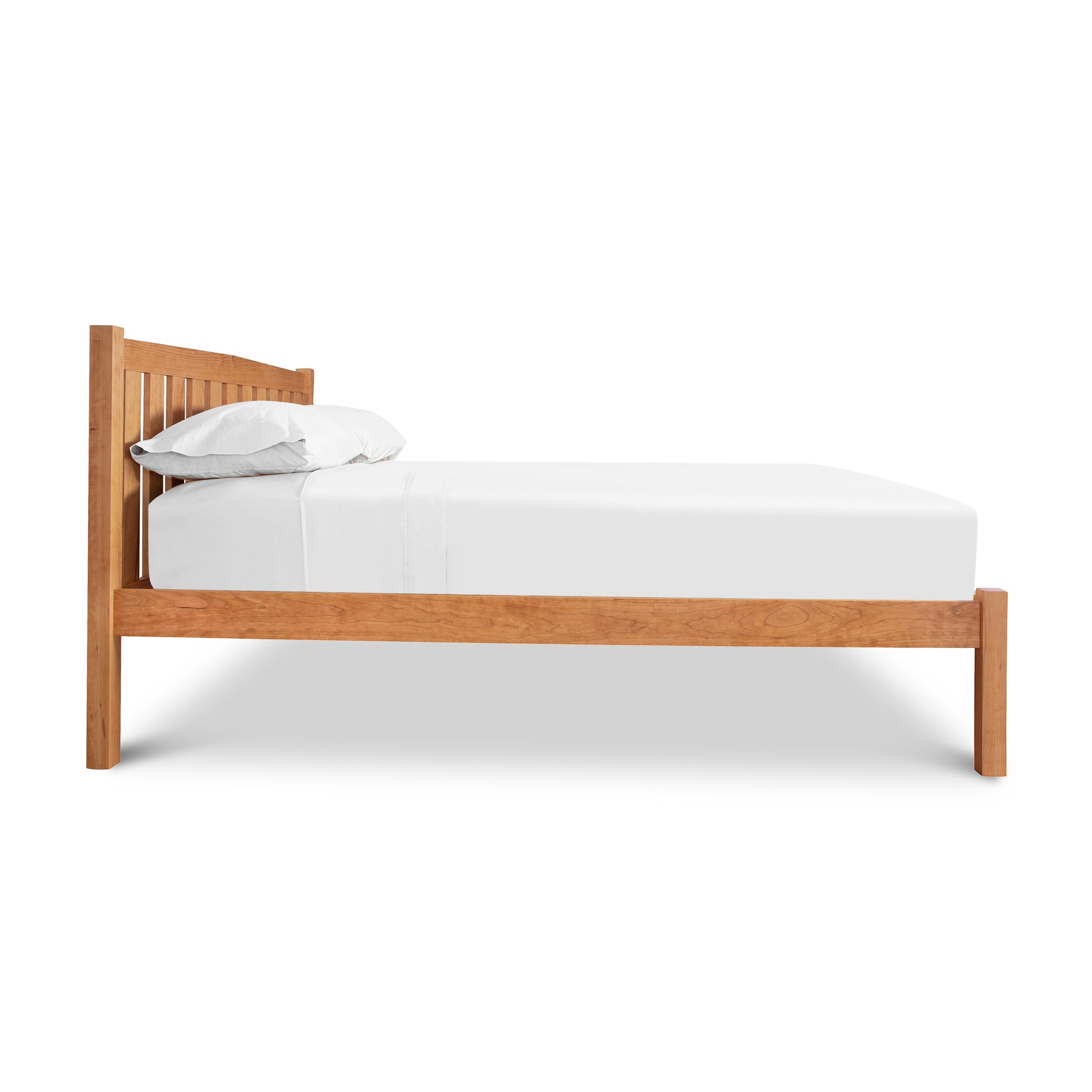 Bennington Bed with Low Footboard by Vermont Furniture Designs with white bedding isolated on a white background.