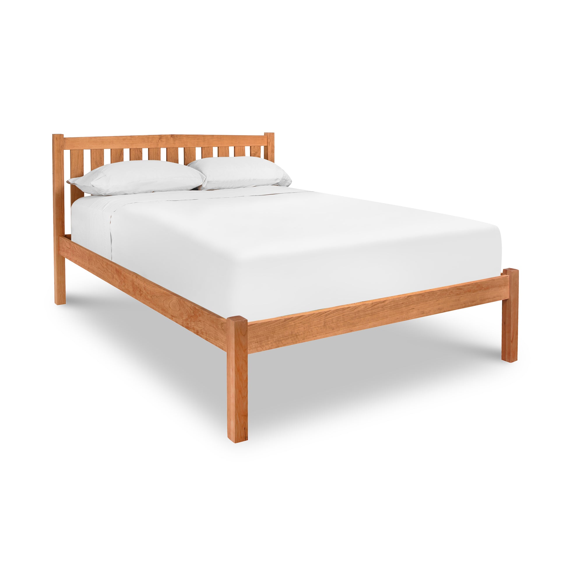 A Bennington Bed with Low Footboard by Vermont Furniture Designs with a white mattress and two white pillows on an isolated white background.