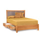 Wooden queen-sized Copeland Furniture Berkeley Cherry Storage Bed with under-bed storage drawers and golden-yellow bedding, isolated on a white background.