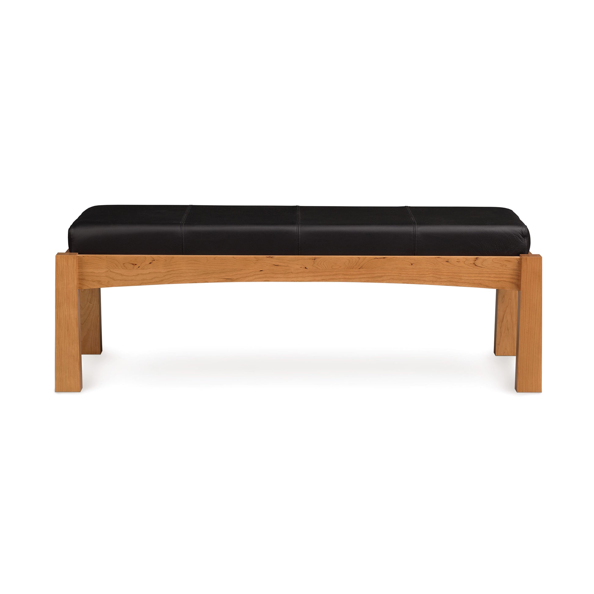 A modern Berkeley Upholstered Bench in cherry wood with a black leather seat, isolated on a white background by Copeland Furniture.
