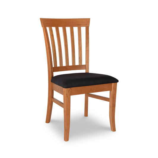Lyndon Furniture Bistro Dining Chair in cherry wood with slatted back and black cushioned seat, angled view.