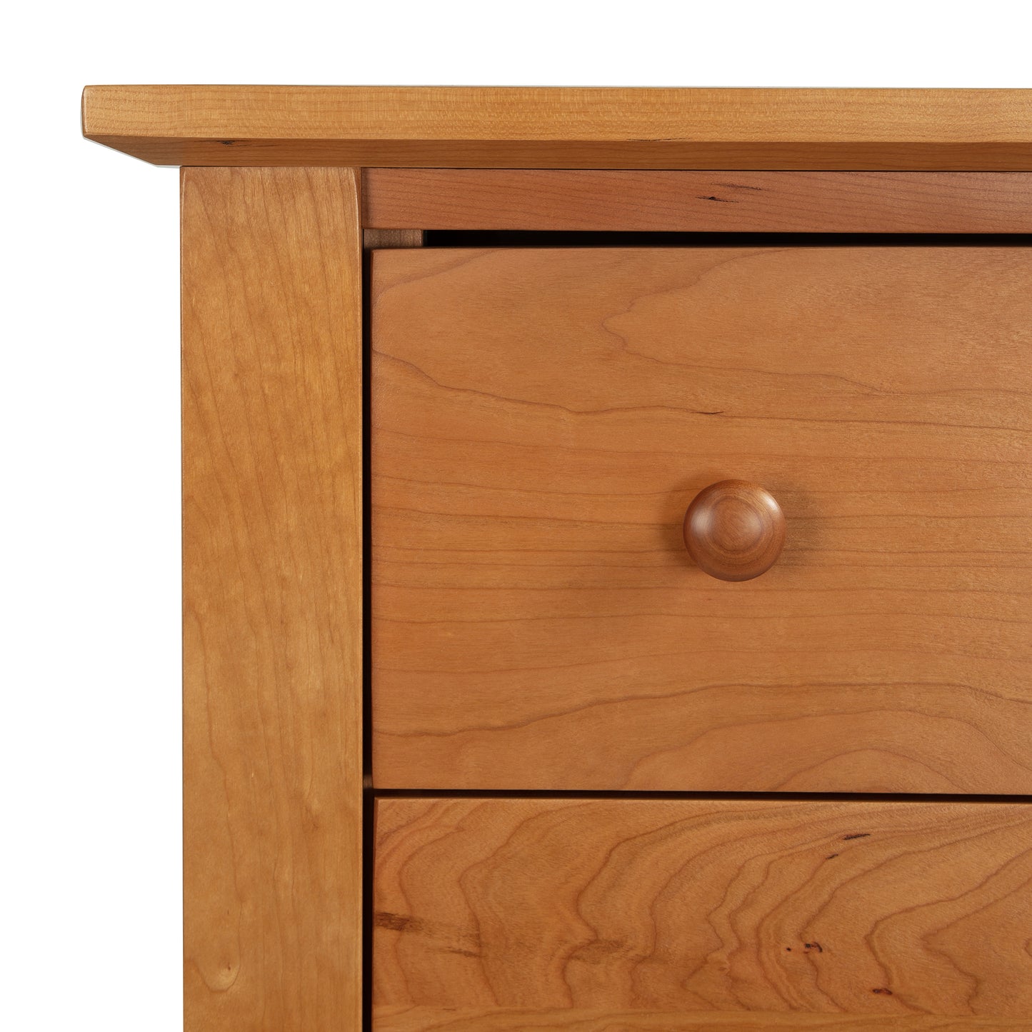 Close-up of the Lyndon Furniture Bow Front 6-Drawer Dresser corner, showcasing light solid wood construction and smooth grain. Features round wooden knobs, simple natural design, handmade in Vermont using premium materials like maple and cherry wood. Perfect example of American-made furniture with a clean and elegant finish.