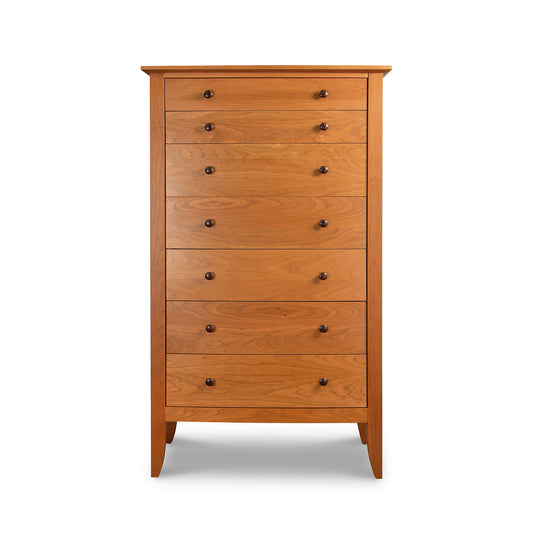 Lyndon Furniture Bow Front 7-Drawer Chest crafted from natural hardwood with dark knobs, showcasing elegant craftsmanship and spacious storage.