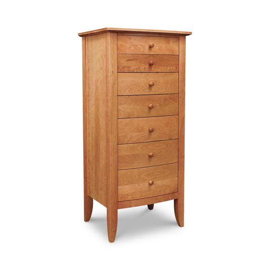 A tall wooden chest of drawers with the Lyndon Furniture Bow Front 7-Drawer Lingerie Chest, a space saving, 7-drawer configuration.