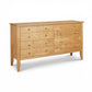 The Bow Front 8-Drawer Dresser by Lyndon Furniture with round wooden knobs, crafted in Vermont from solid wood, highlighting its elegant curved front.