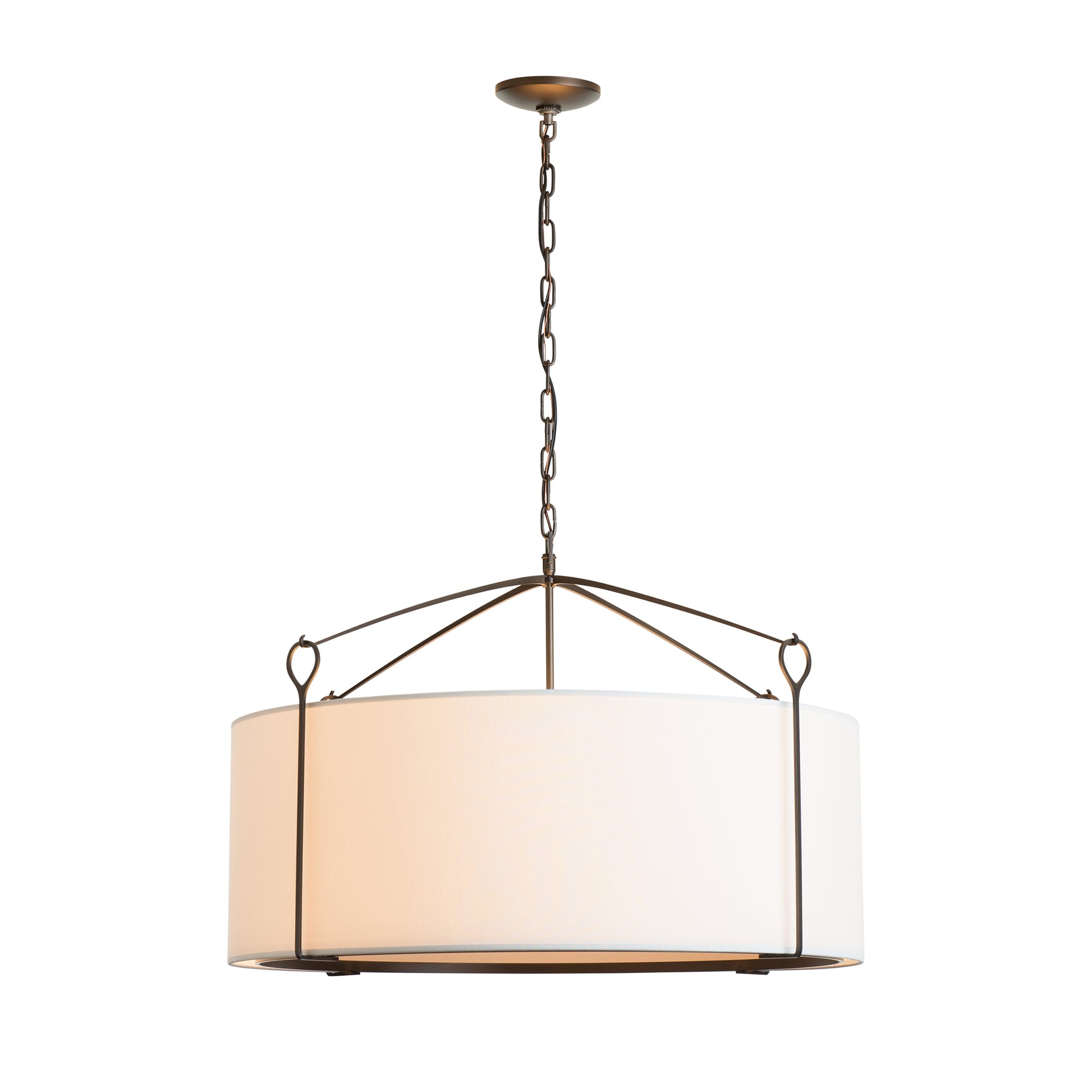 A modern Bow Large Pendant with a white drum shade and an antique bronze frame, suspended by a chain from a circular ceiling mount, crafted by Hubbardton Forge.