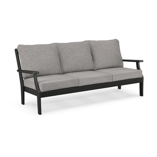A modern POLYWOOD Braxton Deep Seating Sofa with a sleek black frame and light grey cushions, isolated on a white background.