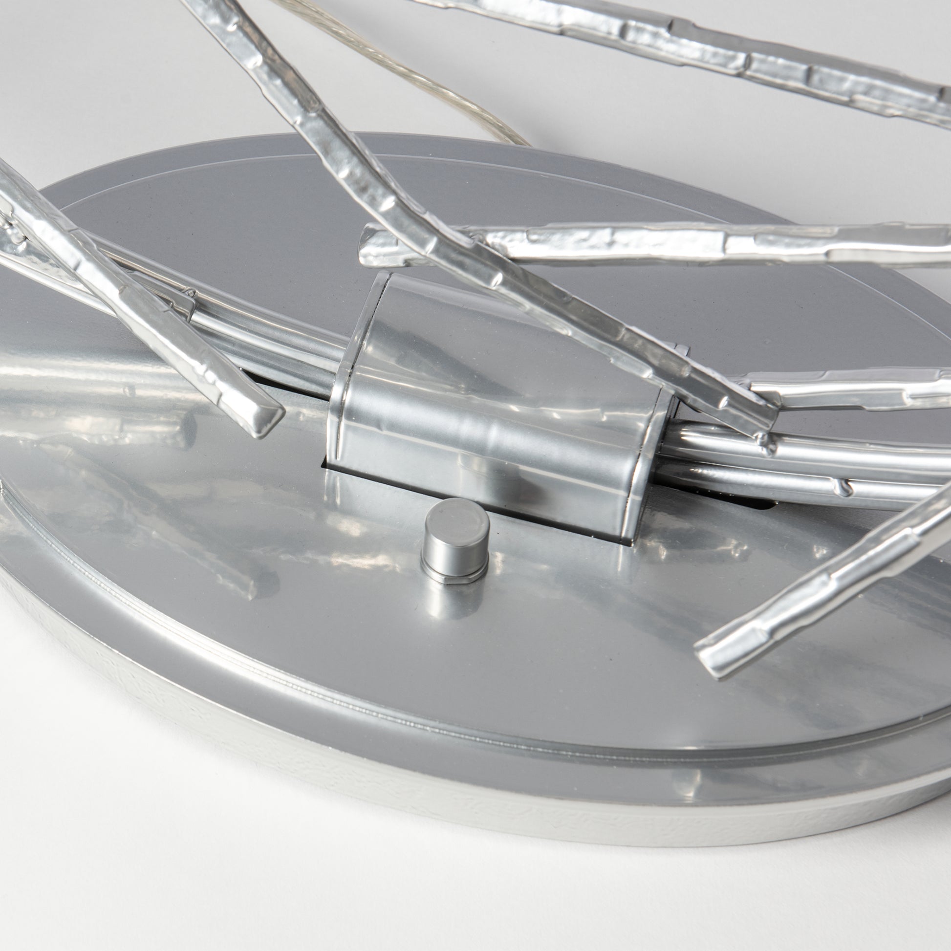 Close-up of the Hubbardton Forge Brindille Ring Lamp base featuring elegant silver rods and refined craftsmanship, highlighting American-made quality.