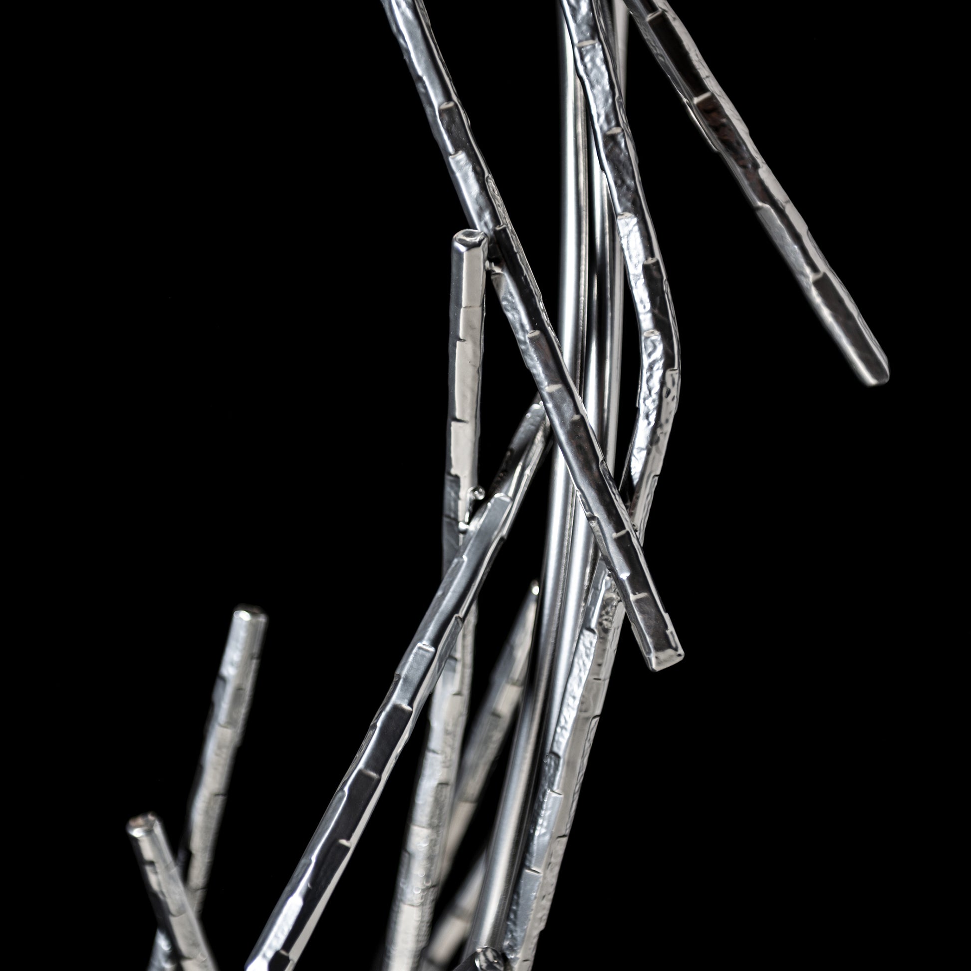 The Brindille Ring Lamp by Hubbardton Forge showcases slender metallic rods in a modern, sculptural design, highlighting fine American craftsmanship.