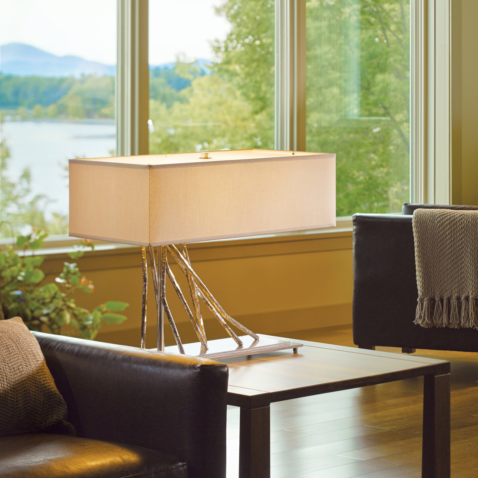 Brindille Table Lamp by Hubbardton Forge elegantly displayed on a side table, highlighting its modern design and craftsmanship.