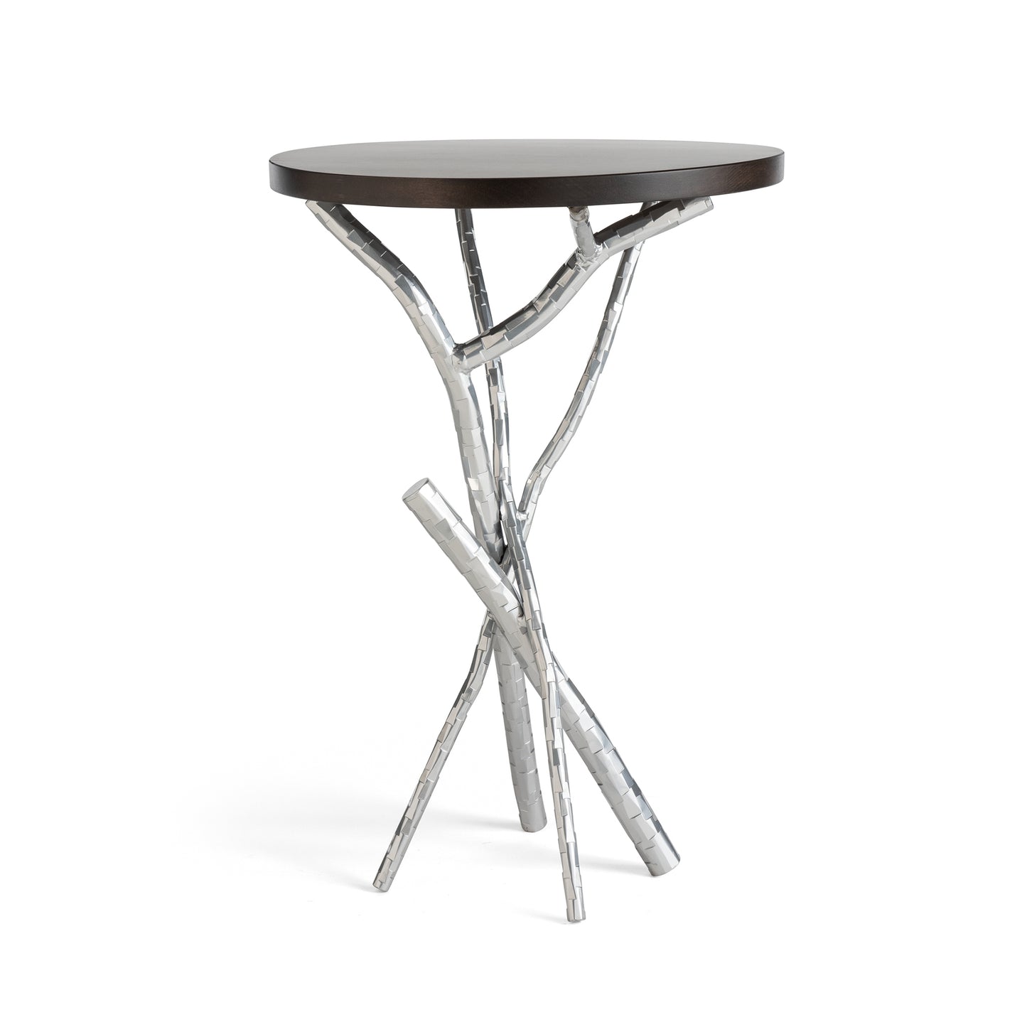 The Brindille Wood Top Accent Table by Hubbardton Forge boasts a small, round Vermont Maple tabletop supported by metal legs that resemble intertwined branches. Its modern and artistic design brings a unique, nature-inspired element to any living space.