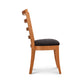 Bromley Ladder-Back Chair by Vermont Woods Studios with natural wood frame and black upholstered seat, side view highlighting elegant craftsmanship.