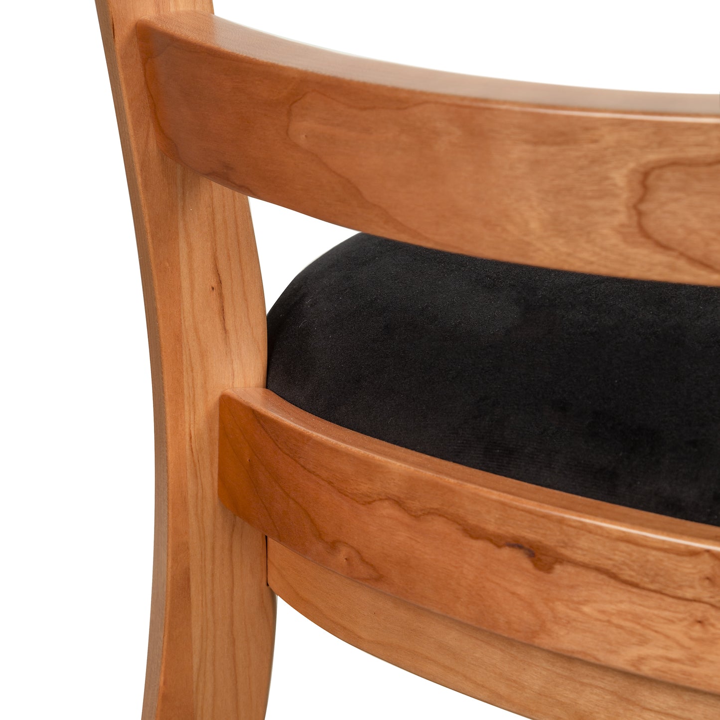 Bromley Ladder-Back Chair by Vermont Woods Studios featuring a distinctive curved backrest and sleek black upholstered seat, handcrafted in the USA.