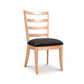 Bromley Ladder-Back Chair by Vermont Woods Studios with natural wood frame and black upholstered seat, expertly handcrafted in the USA.