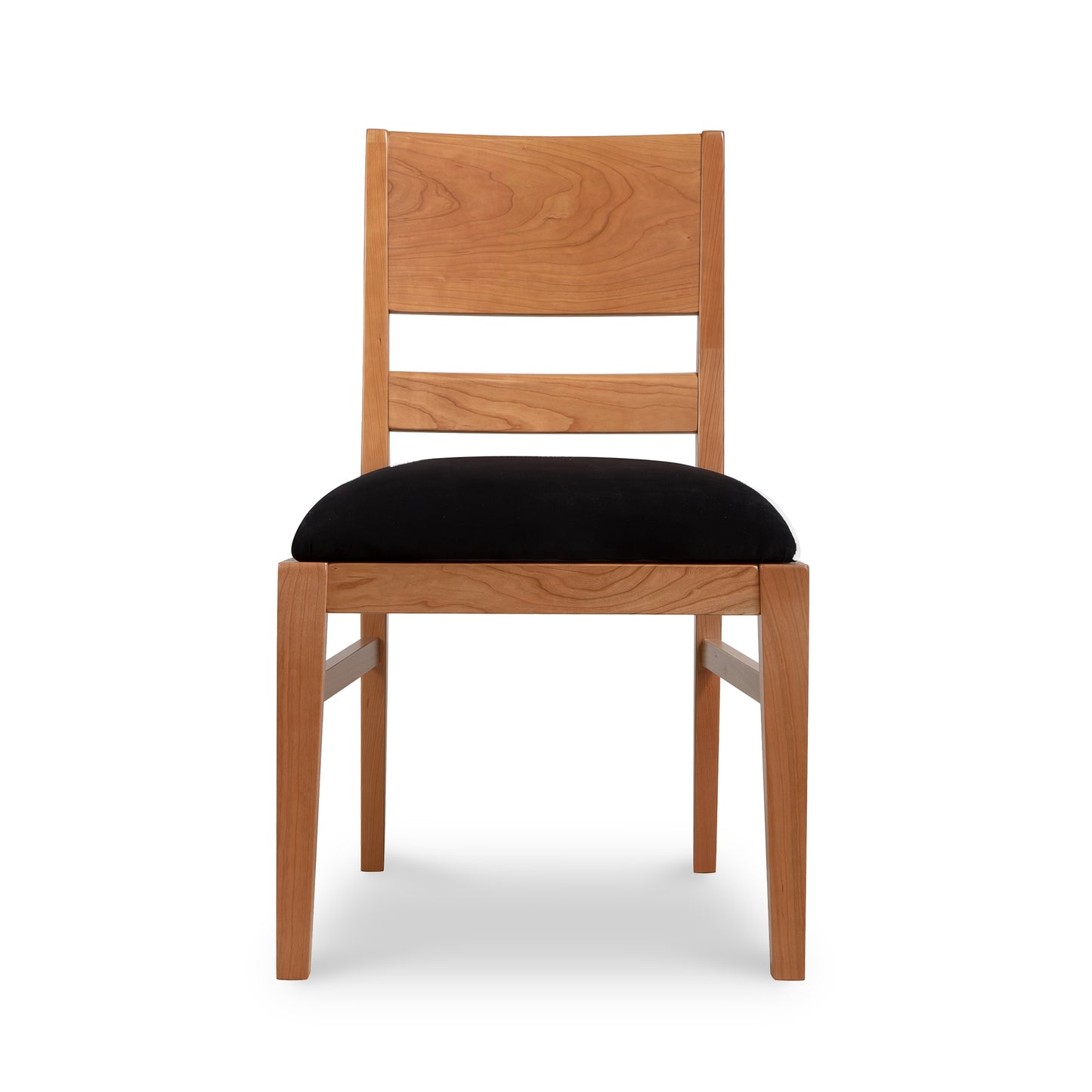 A Scandinavian inspired design Burke Modern Chair from Vermont Woods Studios made of natural solid wood with a black cushion on a white background.