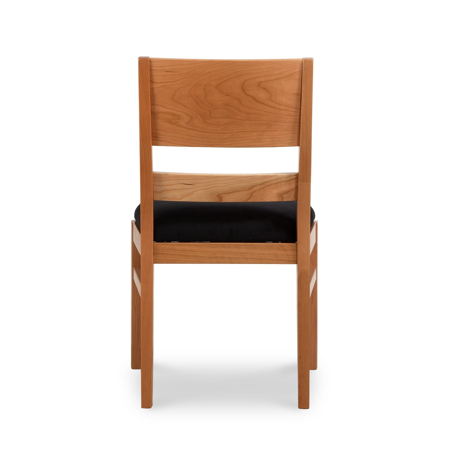 A wooden dining chair with black seat and back.