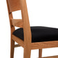 Side view of a Burke Modern Chair by Vermont Woods Studios with a black upholstered seat cushion.