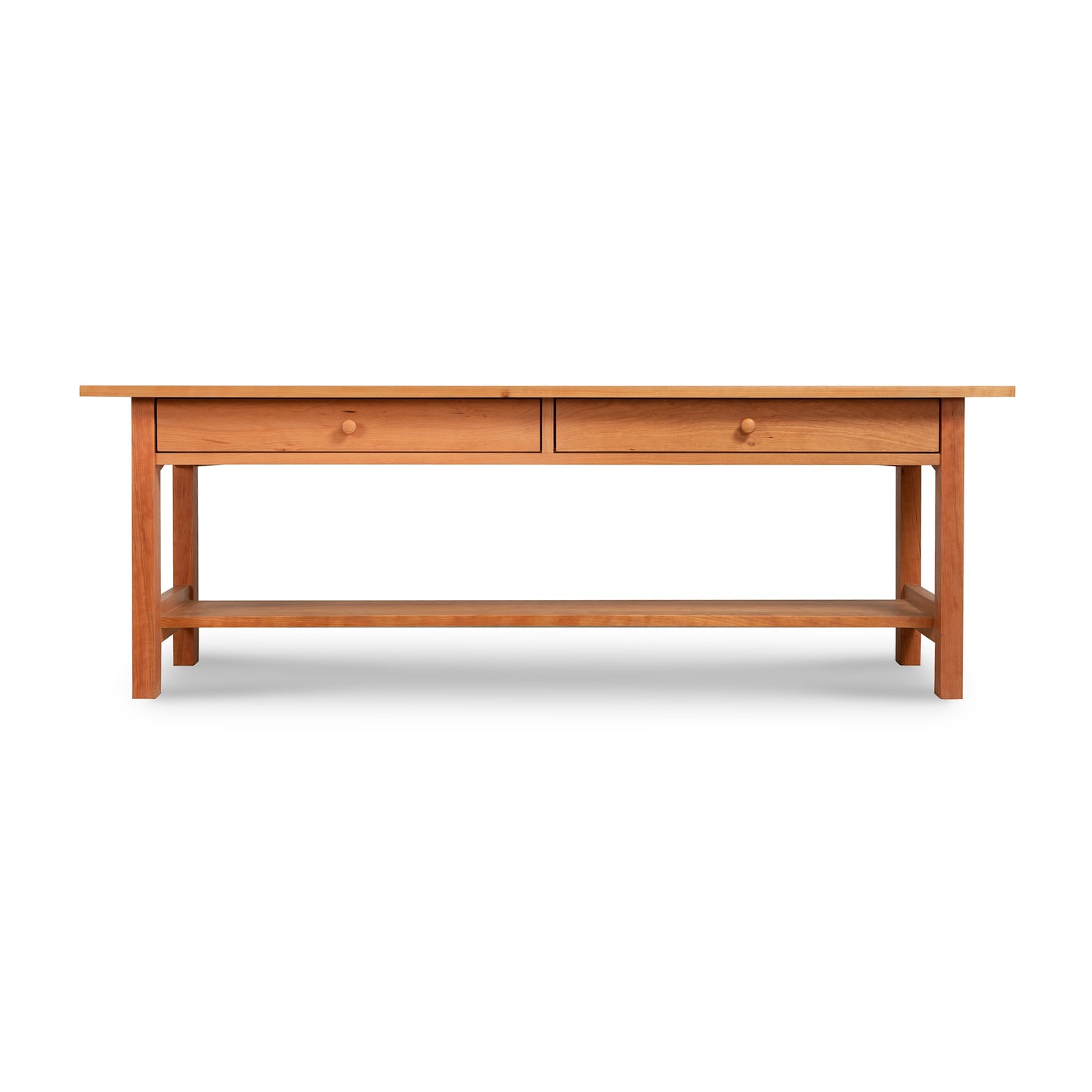 The Vermont Furniture Designs Burlington Shaker 2-Drawer Coffee Table, a low console, features two convenient drawers for storage.