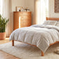 Vermont Furniture Designs Burlington Shaker 6-Drawer Chest and wooden bed showcased in a bright bedroom, highlighting handcrafted American-made quality.