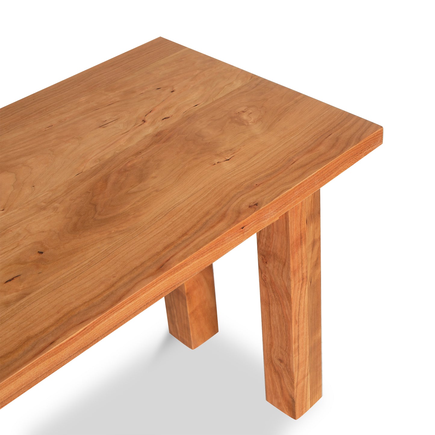 A wooden bench from the Vermont Furniture Designs Burlington Shaker Collection with a smooth finish and visible grain, featuring a simple design with straight legs, shown on a white background.