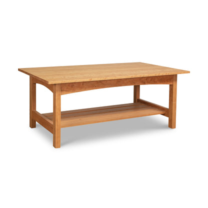 The Vermont Furniture Designs Burlington Shaker Coffee Table is a handmade masterpiece crafted from solid wood. This exquisite piece of furniture features a convenient shelf on top, making it the perfect addition to any living room or sitting area.