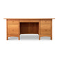 A Vermont Furniture Designs Burlington Shaker Executive Desk, a handmade, solid wood desk with multiple drawers and a central cabinet space, isolated on a white background.