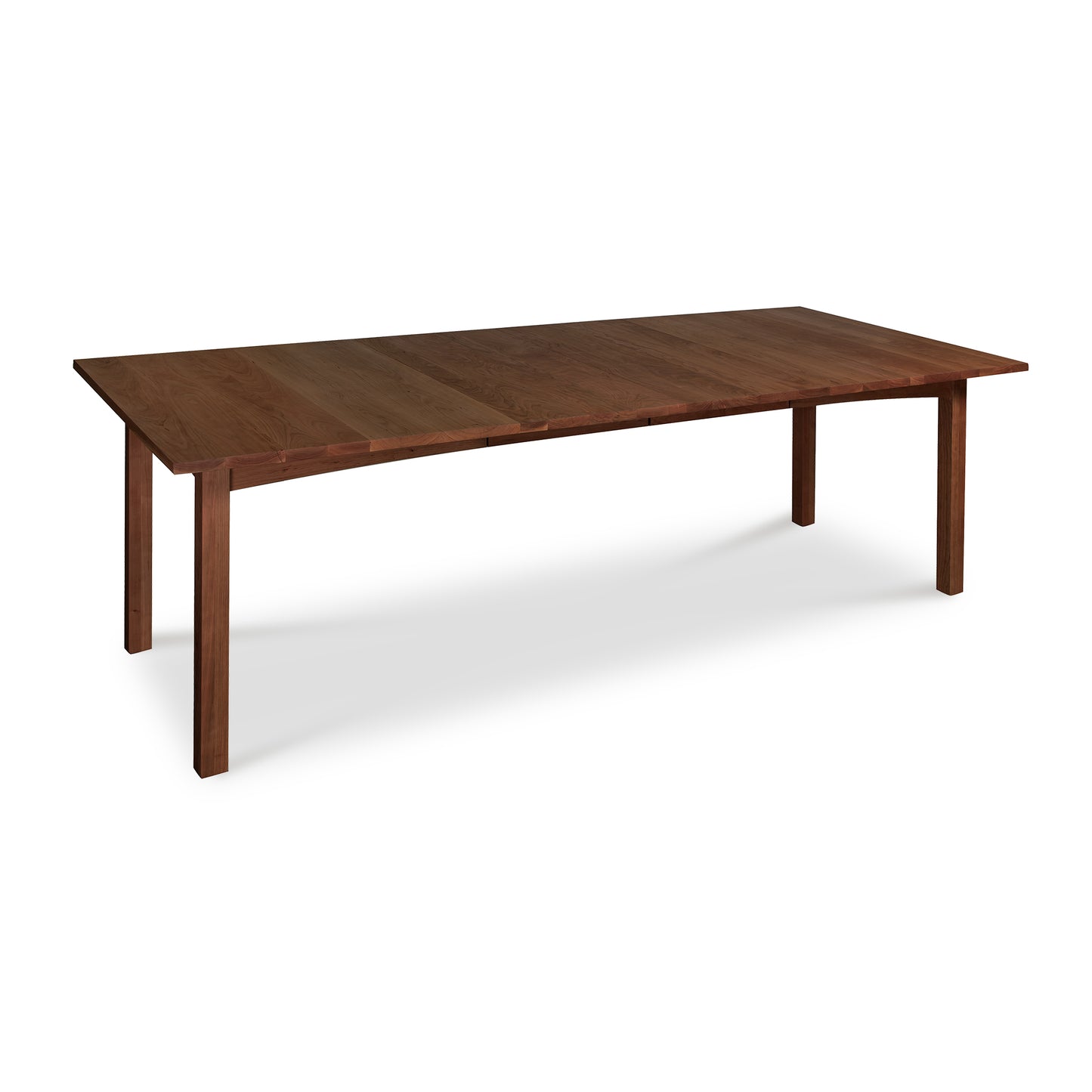 A solid woods Vermont Furniture Designs Burlington Shaker Extension Dining Table in a dining room setting, against a white background.