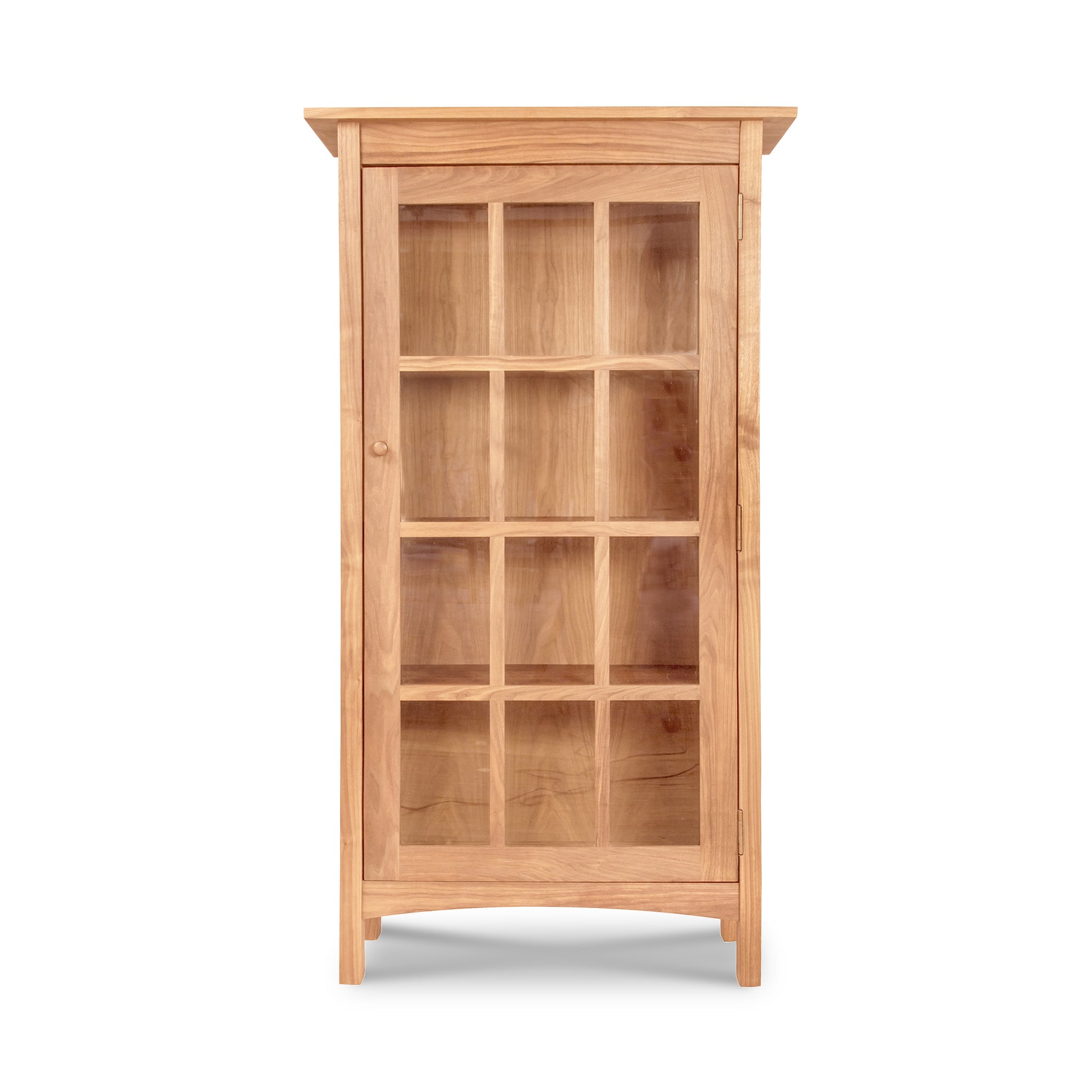 A Burlington Shaker Glass Door Bookcase by Vermont Furniture Designs, combining Shaker style and elegance, showcasing its wooden beauty against a white background.