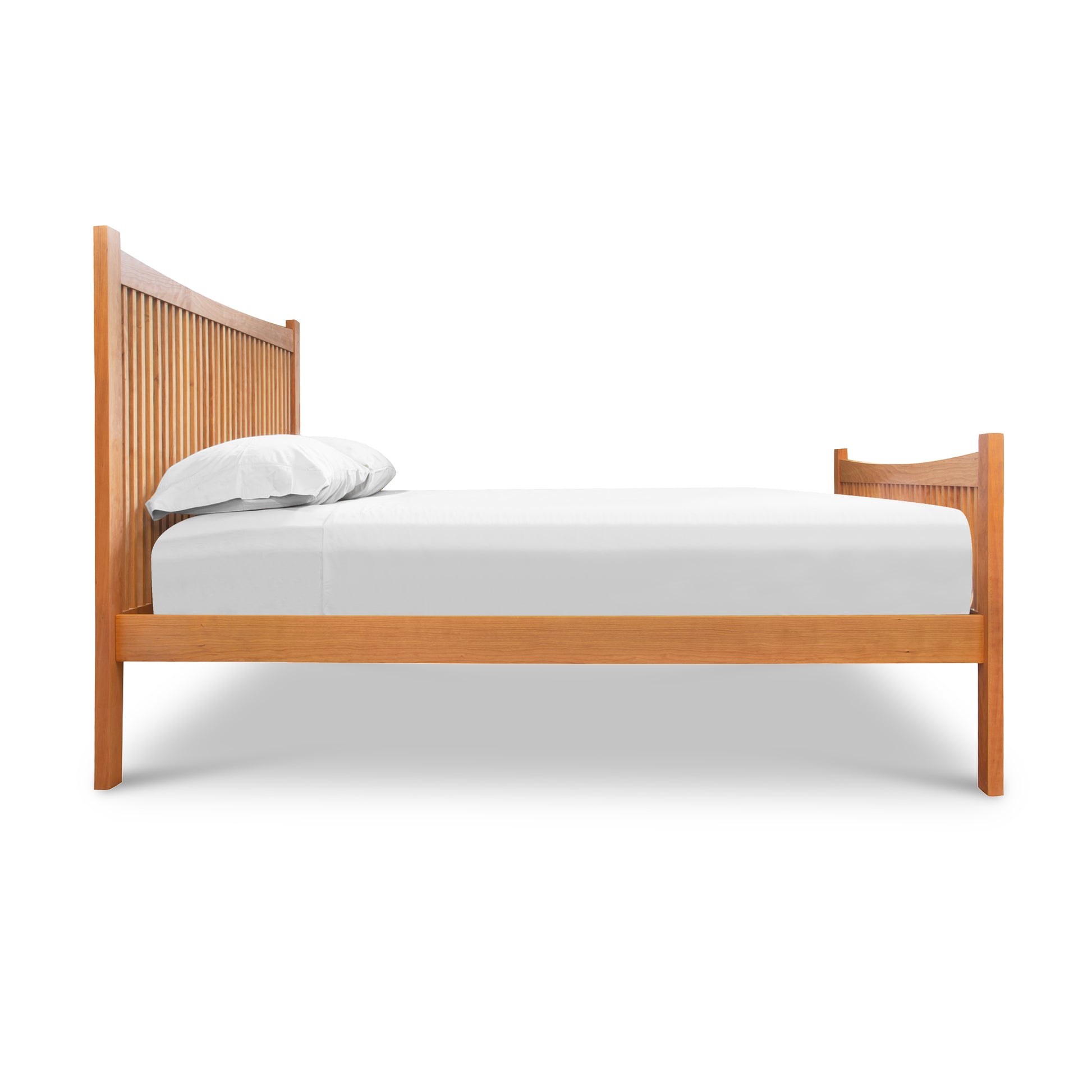 Burlington Shaker High Footboard Bed by Vermont Furniture Designs with vertical slats, hand-crafted in the USA, shown with mattress and white bedding.