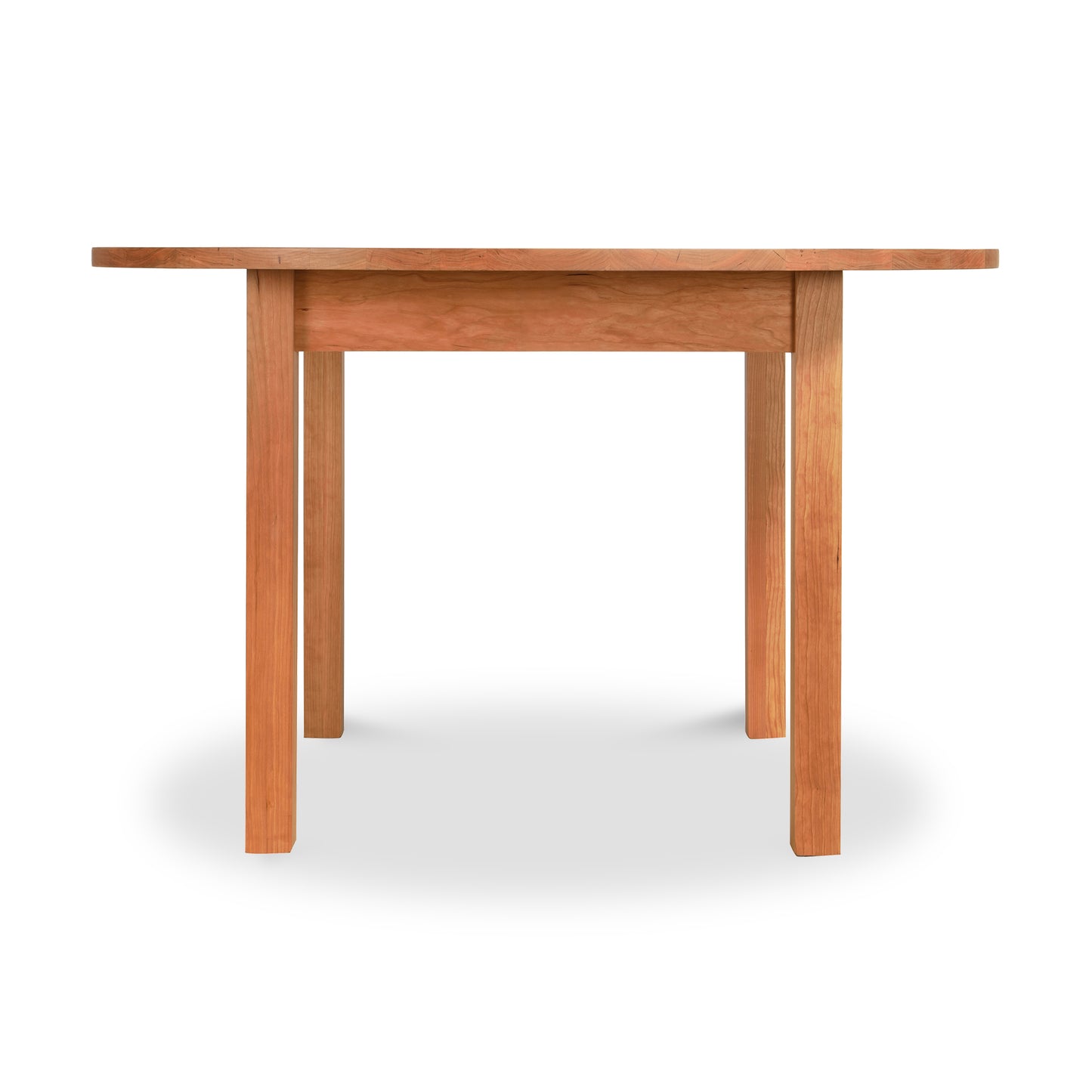 A simple Vermont Furniture Designs Burlington Shaker Round Solid Top Dining Table isolated on a white background.