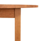 Corner of a Vermont Furniture Designs Burlington Shaker Round Solid Top Dining Table showing the tabletop and leg joint on a white background.