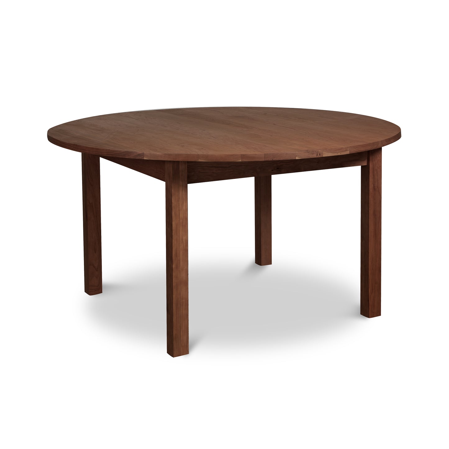 A Burlington Shaker Round Solid Top Dining Table by Vermont Furniture Designs with four legs, isolated on a white background.