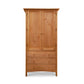 A wooden Burlington Shaker Tall Armoire from Vermont Furniture Designs, with two doors above three drawers, isolated on a white background.