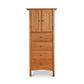 A tall Burlington Shaker style wooden cabinet with drawers and doors by Vermont Furniture Designs.