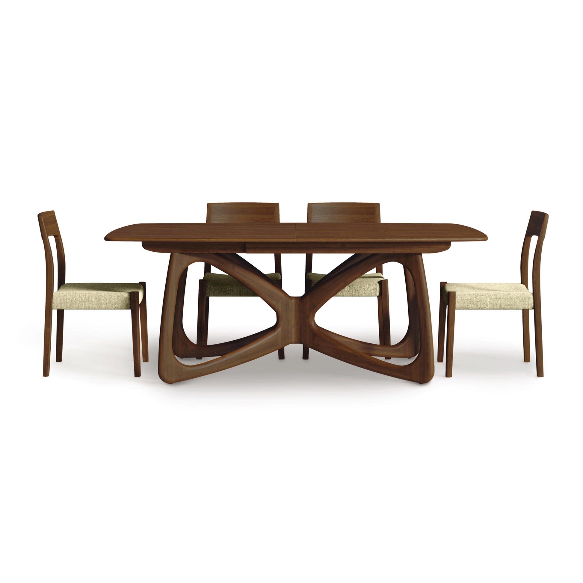Alt text optimized for SEO: "Modern Butterfly Extension Dining Table by Copeland Furniture featuring unique geometric base, sustainably sourced hardwood, paired with four matching light-colored upholstered chairs. Sleek, contemporary solid wood dining set for American made furniture lovers.